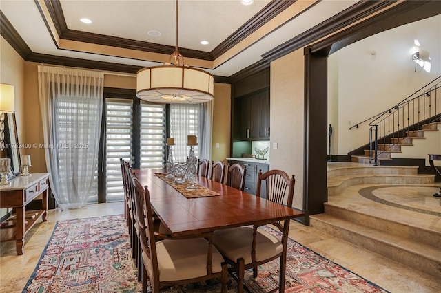 dining area featuring a tray ceiling, crown molding, recessed lighting, and stairs