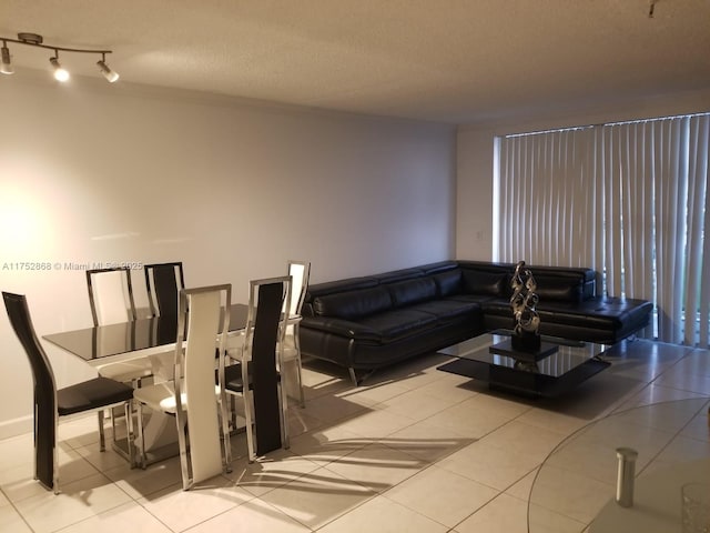 living room featuring a textured ceiling and light tile patterned flooring