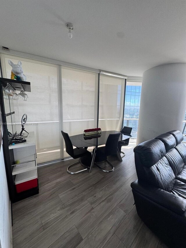 dining area with dark wood-type flooring and floor to ceiling windows