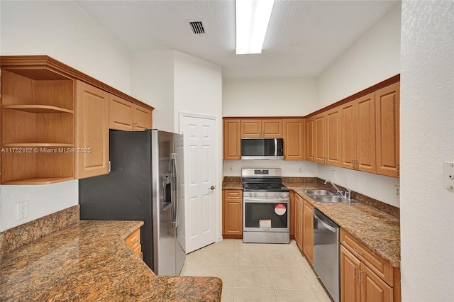 kitchen featuring light tile patterned floors, a sink, visible vents, appliances with stainless steel finishes, and open shelves