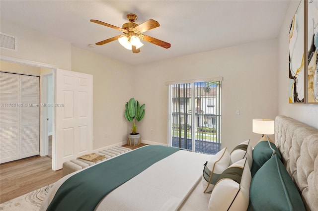 bedroom with light wood finished floors, visible vents, baseboards, a ceiling fan, and access to outside