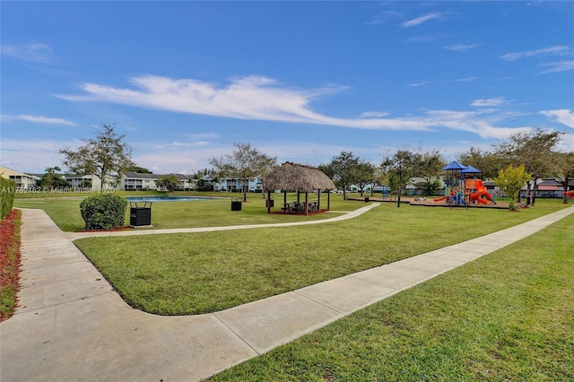 view of property's community with playground community, a yard, and a gazebo