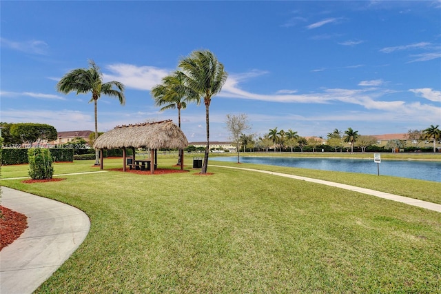 surrounding community featuring a gazebo, a lawn, and a water view