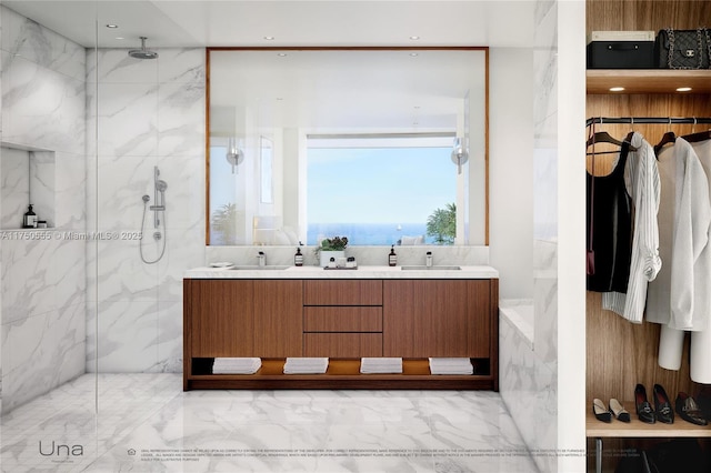 bathroom with a sink, a spacious closet, double vanity, and a marble finish shower