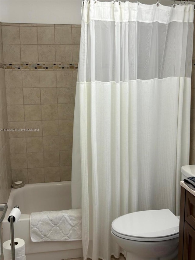 full bath featuring shower / bath combination with curtain, vanity, and toilet