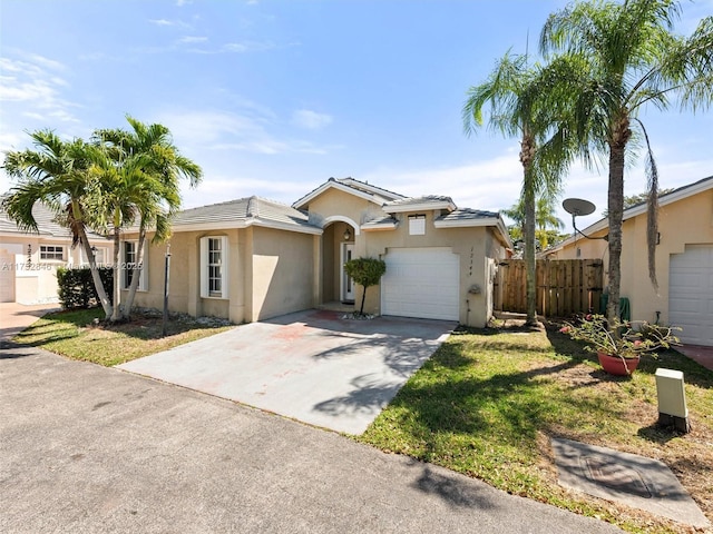 12344 SW 144th Ter, Miami, FL 33186 - ranch-style home with an attached garage, driveway, and stucco siding