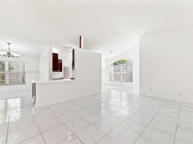 12344 SW 144th Ter, Miami, FL 33186 - unfurnished living room featuring vaulted ceiling, a chandelier, light tile patterned floors, and a textured ceiling