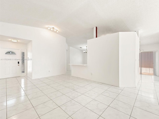 12344 SW 144th Ter, Miami, FL 33186 - unfurnished room with light tile patterned flooring, a chandelier, and a textured ceiling