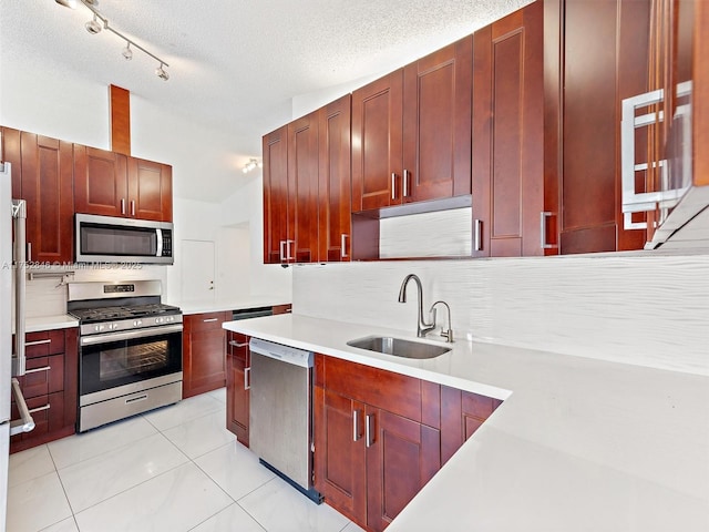 12344 SW 144th Ter, Miami, FL 33186 - kitchen featuring stainless steel appliances, a sink, backsplash, light countertops, and a textured ceiling
