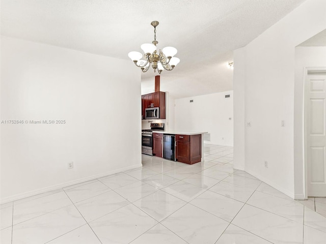 12344 SW 144th Ter, Miami, FL 33186 - kitchen featuring appliances with stainless steel finishes, a chandelier, dark brown cabinets, wine cooler, and light countertops