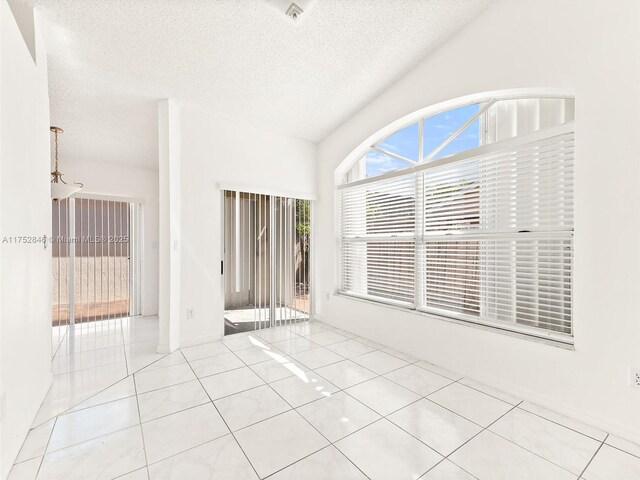 12344 SW 144th Ter, Miami, FL 33186 - empty room featuring tile patterned flooring and a textured ceiling