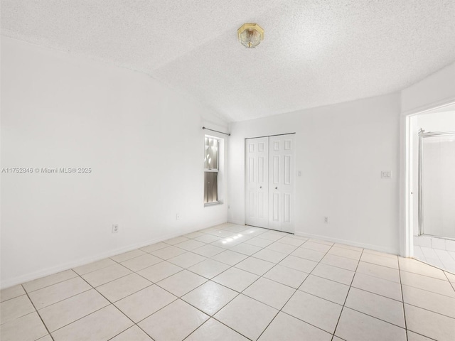 12344 SW 144th Ter, Miami, FL 33186 - unfurnished room featuring a textured ceiling, light tile patterned floors, and vaulted ceiling
