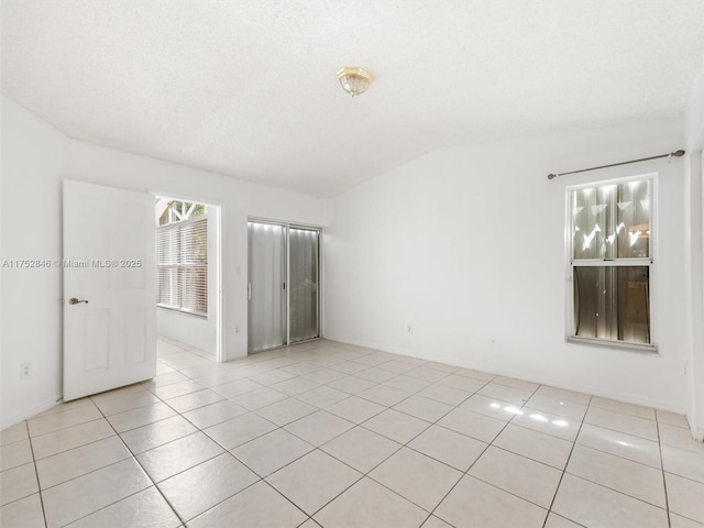 12344 SW 144th Ter, Miami, FL 33186 - spare room with lofted ceiling and light tile patterned floors