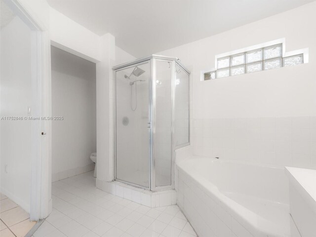 12344 SW 144th Ter, Miami, FL 33186 - bathroom with a stall shower, toilet, tile patterned floors, and a bath