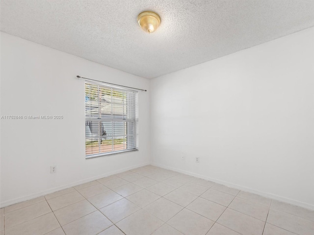 12344 SW 144th Ter, Miami, FL 33186 - spare room featuring a textured ceiling, light tile patterned floors, and baseboards
