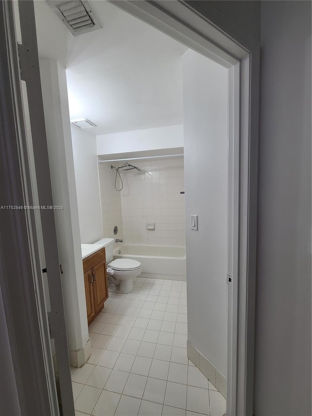 bathroom featuring visible vents, toilet, vanity, shower / tub combination, and tile patterned floors