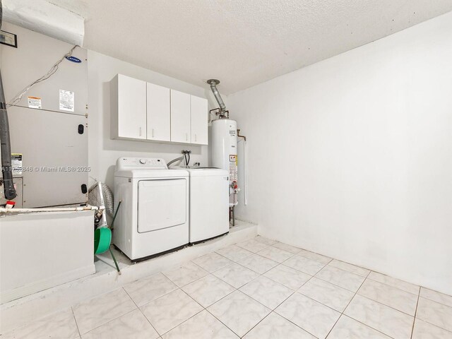 12344 SW 144th Ter, Miami, FL 33186 - laundry room featuring independent washer and dryer, cabinet space, gas water heater, and a textured ceiling