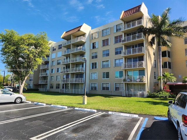 view of building exterior featuring uncovered parking