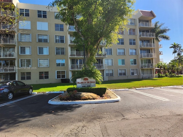 view of building exterior with uncovered parking