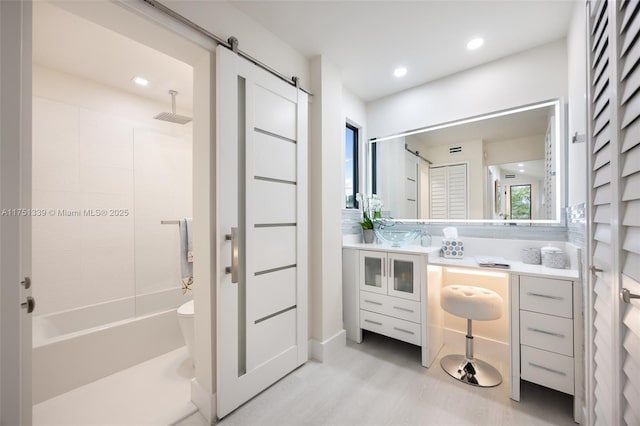 bathroom with toilet, shower / bathing tub combination, vanity, and recessed lighting