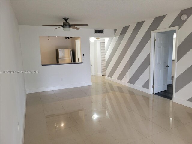 1470 NE 123rd St Unit A204, North Miami, FL 33161 - unfurnished room featuring baseboards, ceiling fan, wallpapered walls, a smoke detector, and an accent wall