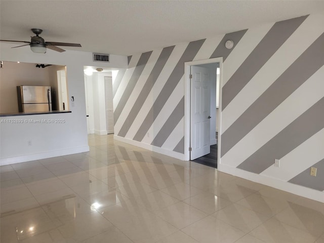 1470 NE 123rd St Unit A204, North Miami, FL 33161 - empty room featuring wallpapered walls, baseboards, an accent wall, and a ceiling fan