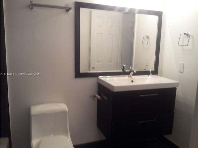 bathroom featuring toilet and vanity