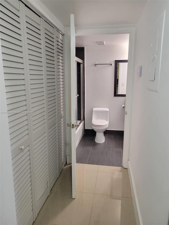 1470 NE 123rd St Unit A204, North Miami, FL 33161 - full bath featuring a closet, toilet, enclosed tub / shower combo, and baseboards