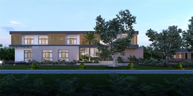 view of front of home featuring a front lawn and stucco siding