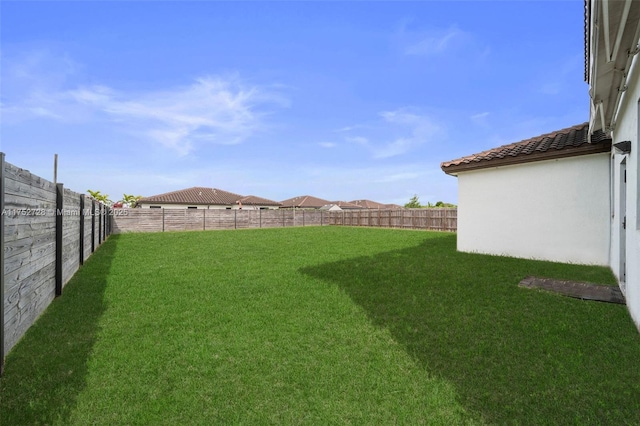 view of yard with a fenced backyard