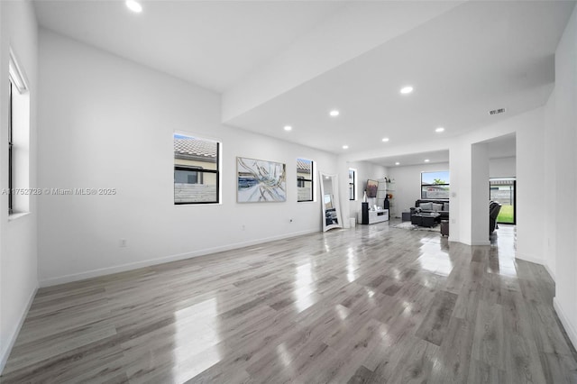 exercise area featuring recessed lighting, baseboards, visible vents, and light wood-style flooring
