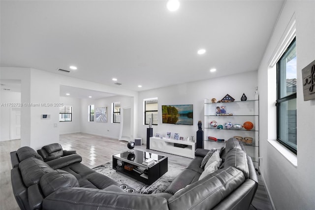 living room featuring visible vents, wood finished floors, a wealth of natural light, and recessed lighting