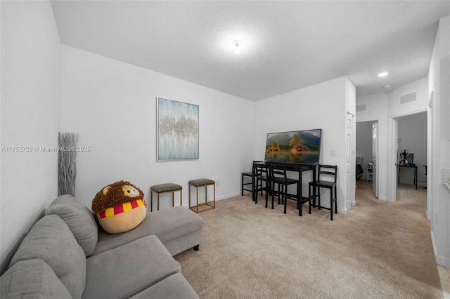 living room featuring carpet floors, baseboards, and visible vents