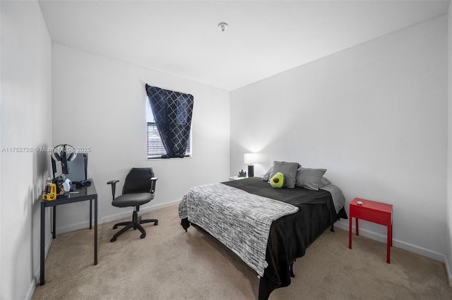 bedroom with baseboards and carpet