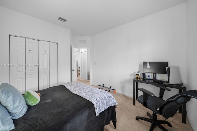 bedroom featuring baseboards, light carpet, a closet, and visible vents