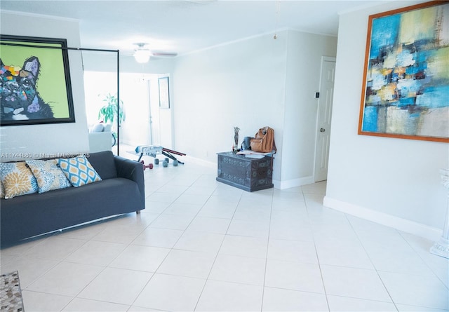 living room with ceiling fan, crown molding, light tile patterned flooring, and baseboards