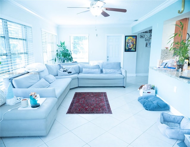 living room featuring baseboards, visible vents, a ceiling fan, crown molding, and light tile patterned flooring