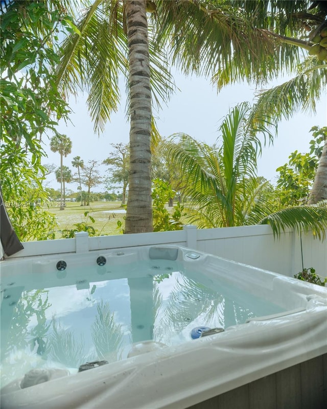 view of swimming pool with a hot tub