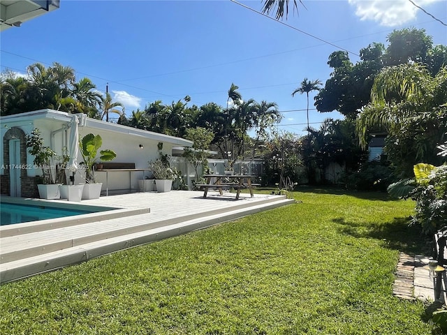 view of yard with an outdoor pool, a patio, and fence