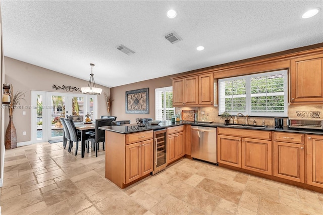 kitchen with beverage cooler, visible vents, dishwasher, dark countertops, and a sink