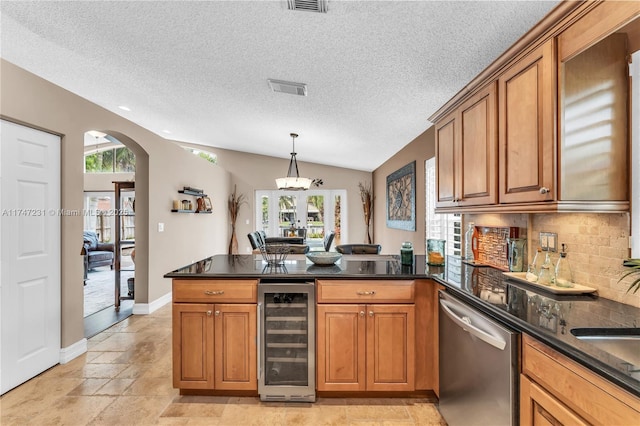 kitchen with a peninsula, wine cooler, stainless steel dishwasher, and brown cabinets