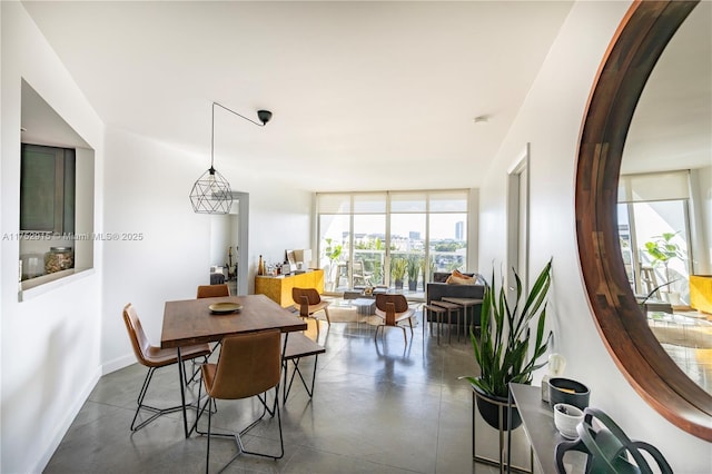 dining area with finished concrete flooring and baseboards