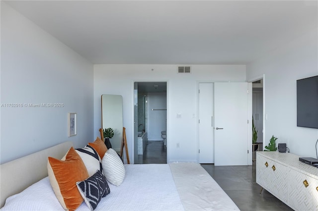 bedroom featuring concrete flooring, visible vents, and ensuite bathroom