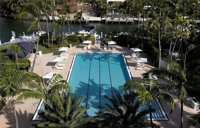 pool with a water view and a patio area