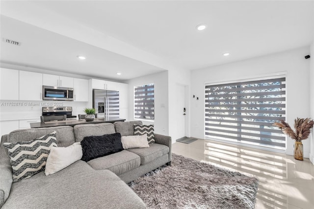 living room featuring visible vents and recessed lighting