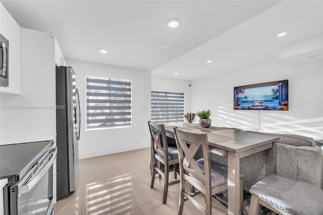 dining area featuring recessed lighting, light tile patterned flooring, and baseboards