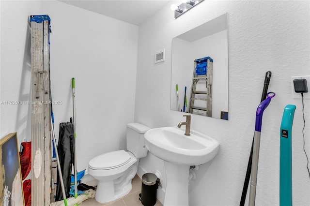 bathroom featuring toilet, visible vents, and tile patterned floors