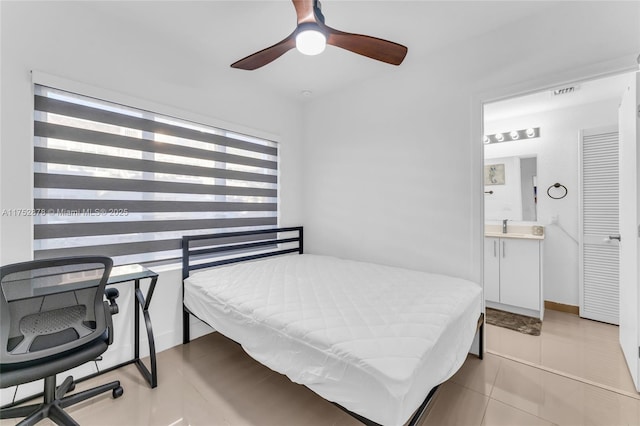 bedroom with light tile patterned floors, ceiling fan, ensuite bathroom, a sink, and visible vents