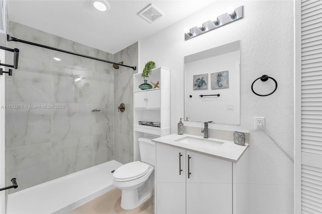 full bath featuring visible vents, toilet, vanity, a shower stall, and a closet