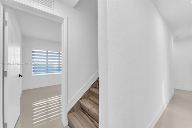 stairs featuring visible vents and baseboards